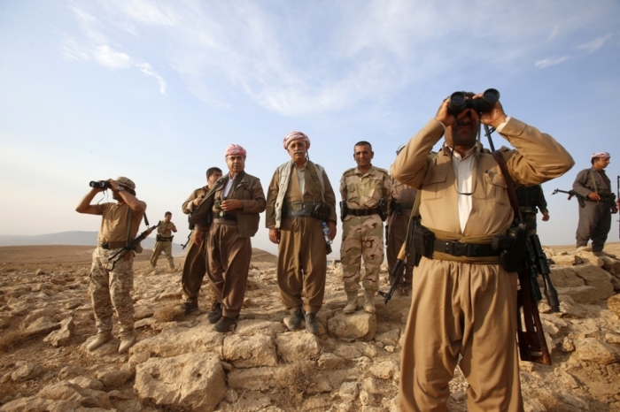 Kurdish Peshmerga forces stand guard near the town of Makhmur, south of Erbil, capital of Iraqi Kurdistan after Islamic State insurgents withdrew Aug. 18, 2014.