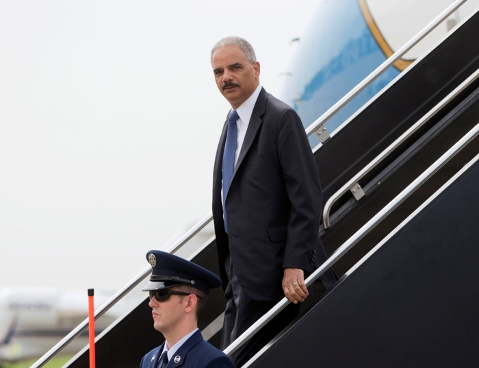 U.S. Attorney General Eric Holder arrives at Lambert-St. Louis International Airport Aug. 20, 2014. Holder visited Ferguson, Missouri, on Wednesday, hours after nearly 50 protesters were arrested in the 11th straight night of demonstrations over the Aug. 9 fatal shooting of Michael Brown, an unarmed black teenager, by a white police officer. The St. Louis County prosecutor's office will also begin presenting evidence on Wednesday to a regularly seated grand jury investigating the shooting death of Brown.