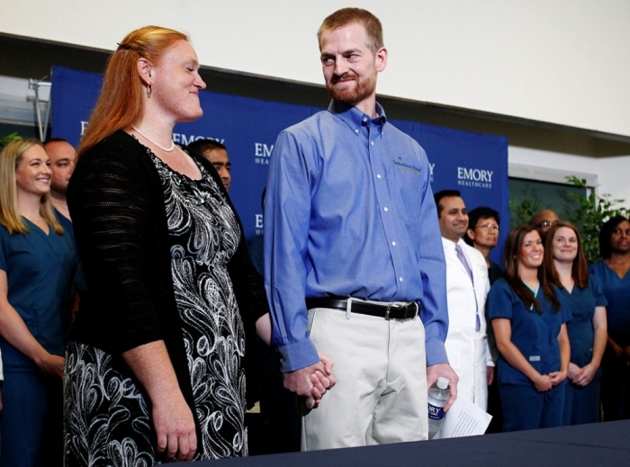 Dr. Kent Brantly who contracted the deadly virus Ebola, looks at his wife Amber during a press conference at Emory University Hospital in Atlanta, Georgia, Aug. 21, 2014. The American doctor along with a second American aid worker who contracted Ebola treating victims of the deadly virus in Liberia have recovered and were discharged by the Atlanta hospital that treated them with an experimental drug.