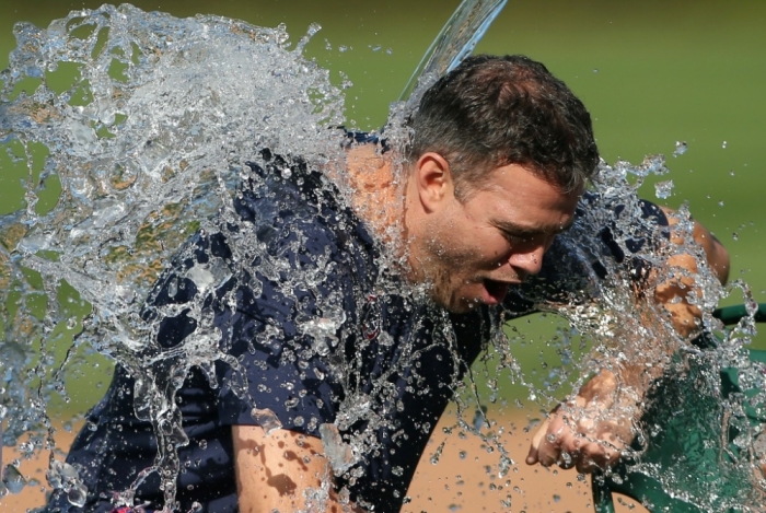Chicago Cubs vice president of baseball operations Theo Epstein is dunked with a bucket of water as part of the ice bucket challenge in awareness for ALS research after the game between the Cubs and Milwaukee Brewers at Wrigley Field, Chicago, Illinois, Aug. 14, 2014.