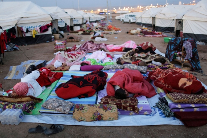 Displaced people from the minority Yazidi sect, who fled violence in the Iraqi town of Sinjar, sleep on the ground at Bajed Kadal refugee camp, southwest of Dohuk province, August 23, 2014.