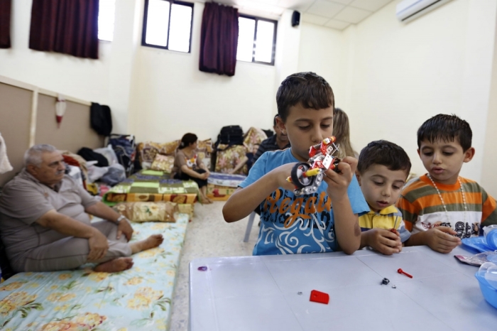 Iraqi Christian children from Mosul, who fled with their families from violence in their country, play at Mar Elias Monastery Church in Amman August 21, 2014. Hundreds of thousands of Iraqis have fled their homes since the militant Islamic State group swept through much of the north and west of Iraq in June, threatening to break up the country.
