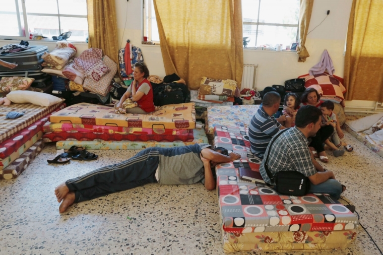 Iraqi Christians from Mosul, who fled from violence in their country, rest at the Latin Patriarchate Church in Amman August 21, 2014. Hundreds of thousands of Iraqis have fled their homes since the militant Islamic State group swept through much of the north and west of Iraq in June, threatening to break up the country.