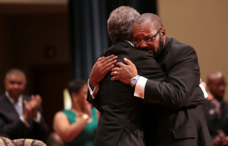Pastor Charles Ewing (R), the uncle of Michael Brown, embraces Rev. Al Sharpton after delivering the eulogy during the funeral services for Michael Brown at Friendly Temple Missionary Baptist Church in St. Louis, Missouri, Aug. 25, 2014.