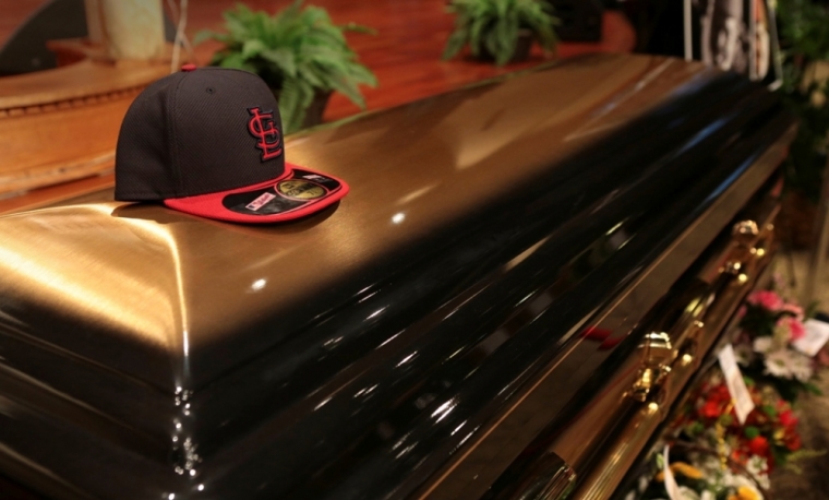 A baseball cap sits on top of the casket of Michael Brown inside Friendly Temple Missionary Baptist Church before the start of funeral services in St. Louis, Missouri, Aug. 25, 2014.