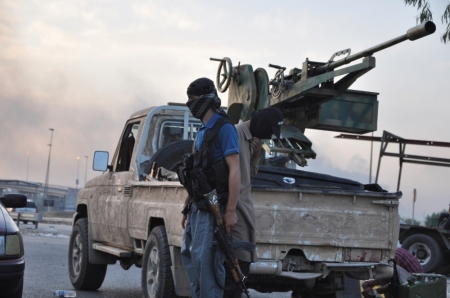 Fighters of the Islamic State stand guard at a checkpoint in the northern Iraq city of Mosul, June 11, 2014. ISIS fighters have seized Iraq's second biggest city Mosul and Tikrit, home town of former dictator Saddam Hussein, as well as other towns and cities north of Baghdad.