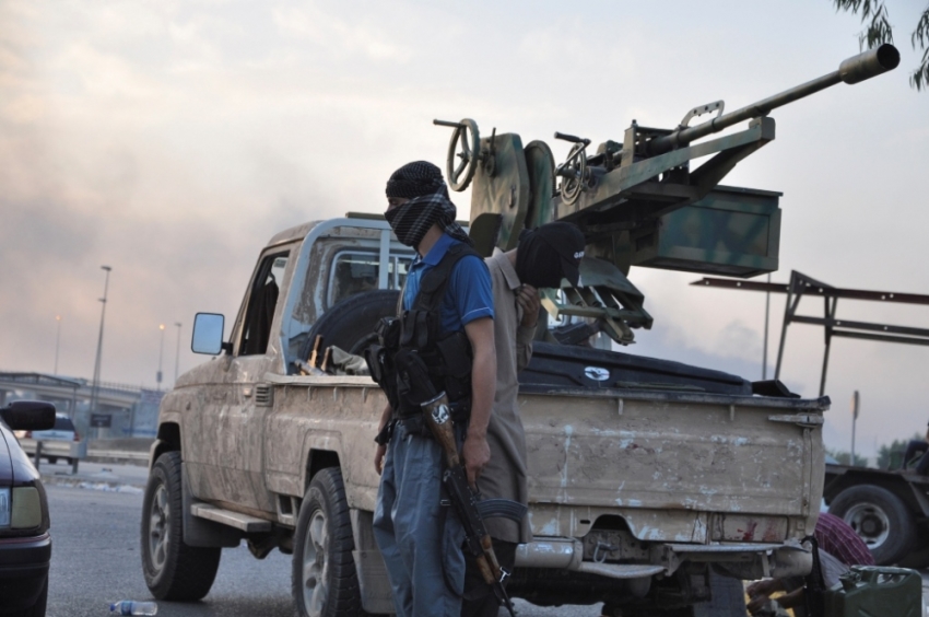 Fighters of the Islamic State stand guard at a checkpoint in the northern Iraq city of Mosul, June 11, 2014. ISIS fighters have seized Iraq's second biggest city Mosul and Tikrit, home town of former dictator Saddam Hussein, as well as other towns and cities north of Baghdad.