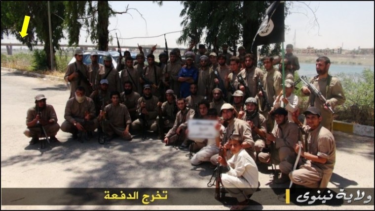 Islamic State terrorists huddle in for a large group picture in front of the Tigris River. Bellingcat claims this is their graduation photo.