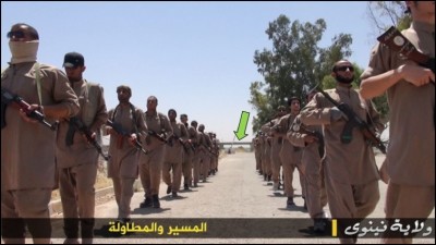 Islamic State members are marching during their training. The bridge in the background was key in helping Bellingcat confirm the location of the training camp.