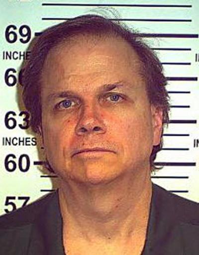 Mark David Chapman posing for a mugshot in 2013.