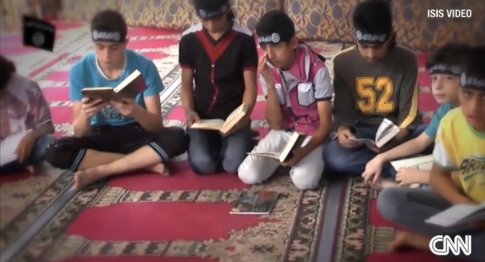 Young boys being taught by ISIS at Syrian children's camps in a video posted in August 2014.