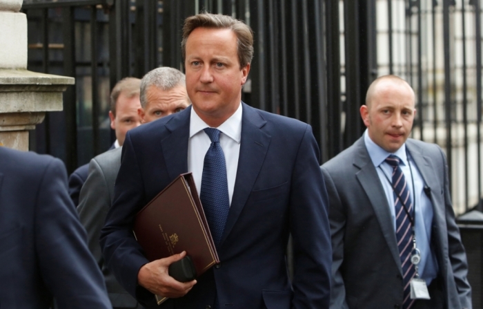 Britain's Prime Minister David Cameron walks to Parliament after leaving Number 10 Downing Street in London September 1, 2014. Cameron will announce new laws on Monday to try to stop radicalised Britons returning from Syria and Iraq launching attacks on British soil, after a video purportedly showed a London-accented man beheading a U.S. journalist.