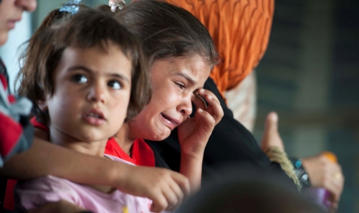 A child cries in a military helicopter after being evacuated by Iraqi forces from Amerli, north of Baghdad, Aug. 29, 2014. A home to around 180,000 people, mostly Turkmen Shi'ites, the small town of Amerli is still holding out against repeated attacks by Islamic State fighters despite the fall of all the 34 villages surrounding it.