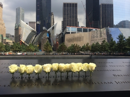 A line of white roses mark the name of Robert Clinton Kennedy etched in the bronze panel around one of the Memorial pools at the National September 11 Memorial, New York, Sept. 10, 2014.