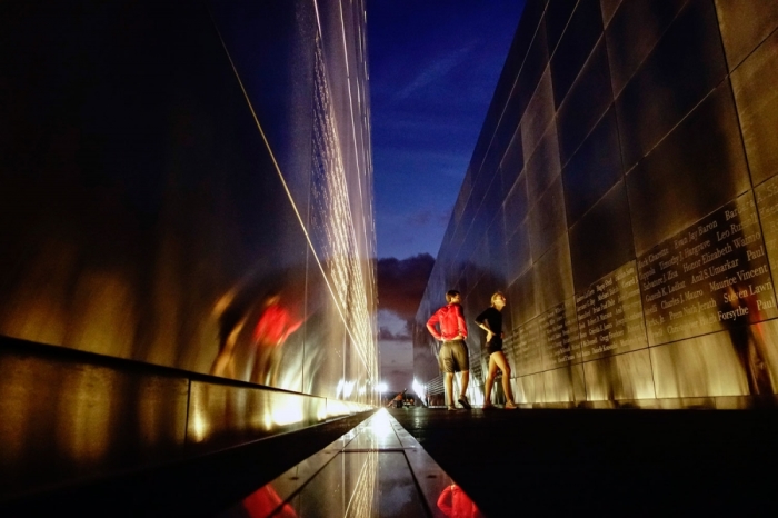 People walk through the 9/11 Empty Sky memorial ahead of the 13th anniversary of the 9/11 attacks on the World Trade Center, in Jersey City, New Jersey, Sept. 10, 2014.