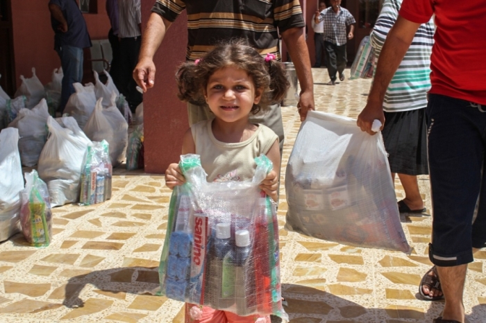 A little girl in Iraq picking up basic supplies in this undated photo.