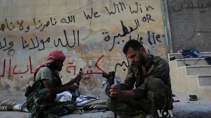 Free Syrian Army rebels cleaning their AK47 rifles in Aleppo, Syria during the civil war in 2012. One faction within the FSA was alleged to have reached a ceasefire with ISIS.
