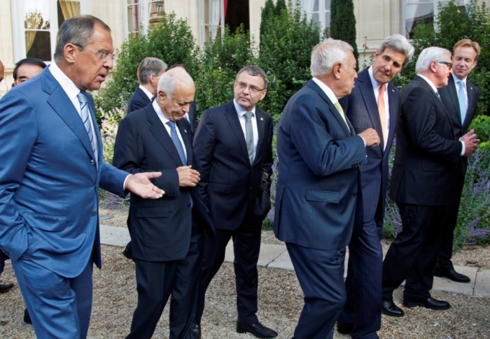 From left, Russian Foreign Minister Sergei Lavrov, Secretary General of the Arab League Nabil al Arabi, Czech Foreign Minister Lubomir Zaoralek, Spanish Foreign Minister Jose Manuel Garcia-Margallo, U.S. Secretary of State John Kerry, German Foreign Minister Frank-Walter Steinmeier, Norwegian Foreign Minister Borge Brende leave after a family photo during the International Conference on Peace and Security in Iraq, at the Quai d'Orsay in Paris Sept. 15, 2014. French President Hollande called on Monday for a global response to counter Islamic State militants during an International conference bringing together about 30 countries to discuss how to cooperate in the fight against Islamic State militants, saying the group posed a security threat the world over.