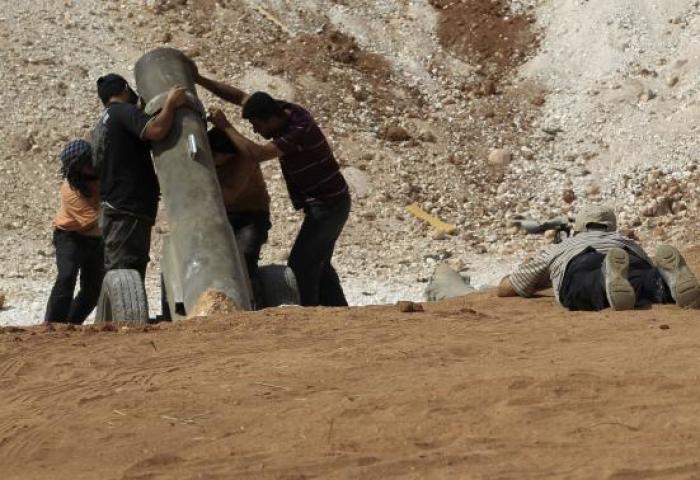 Rebels in the Free Syrian Army prepare a locally made cannon for battle on the frontlines of Wadi Al-Dayf camp in the southern Idlib countryside in September of 2014.
