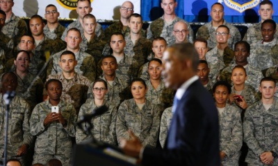 Military personnel listen as President Barack Obama speaks.