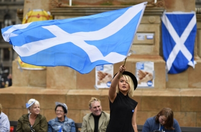 Woman waving the Scottish flag in this undated photo.