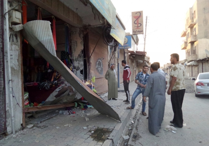 People inspect a shop damaged after what Islamist State militants say was a U.S. drone crashed into a communication station nearby in Raqqa, Syria, September 23, 2014. The United States and several Gulf Arab allies launched air and missile strikes on Islamic State strongholds in Syria on Tuesday, U.S. officials said, opening a new, far more complicated front in the battle against the militants.