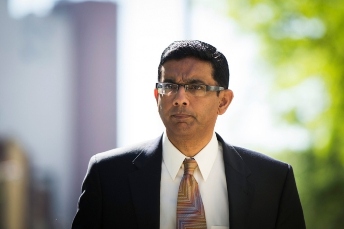 Conservative commentator and best-selling author, Dinesh D'Souza exits the Manhattan Federal Courthouse after pleading guilty in New York, May 20, 2014.