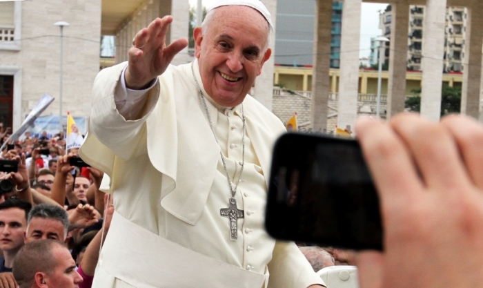 Pope Francis waves during his visit in Tirana, September 21, 2014. Pope Francis is on a one-day trip to Albania, his first to a European country, to pay tribute to followers of all religions who suffered some of the worst persecution in the 20th century, and to hold up the impoverished nation as a model of inter-religious harmony.
