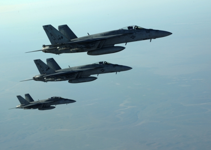 A formation of U.S. Navy F-18E Super Hornets leaves after receiving fuel from a KC-135 Stratotanker over northern Iraq on September 23, 2014. These aircraft were part of a large coalition strike package that was the first to strike ISIL targets in Syria.