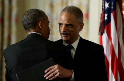 U.S. Attorney General Eric Holder (R) embraces President Barack Obama (L) after the president announced Holder's resignation in the White House State Dining Room in Washington, September 25, 2014.