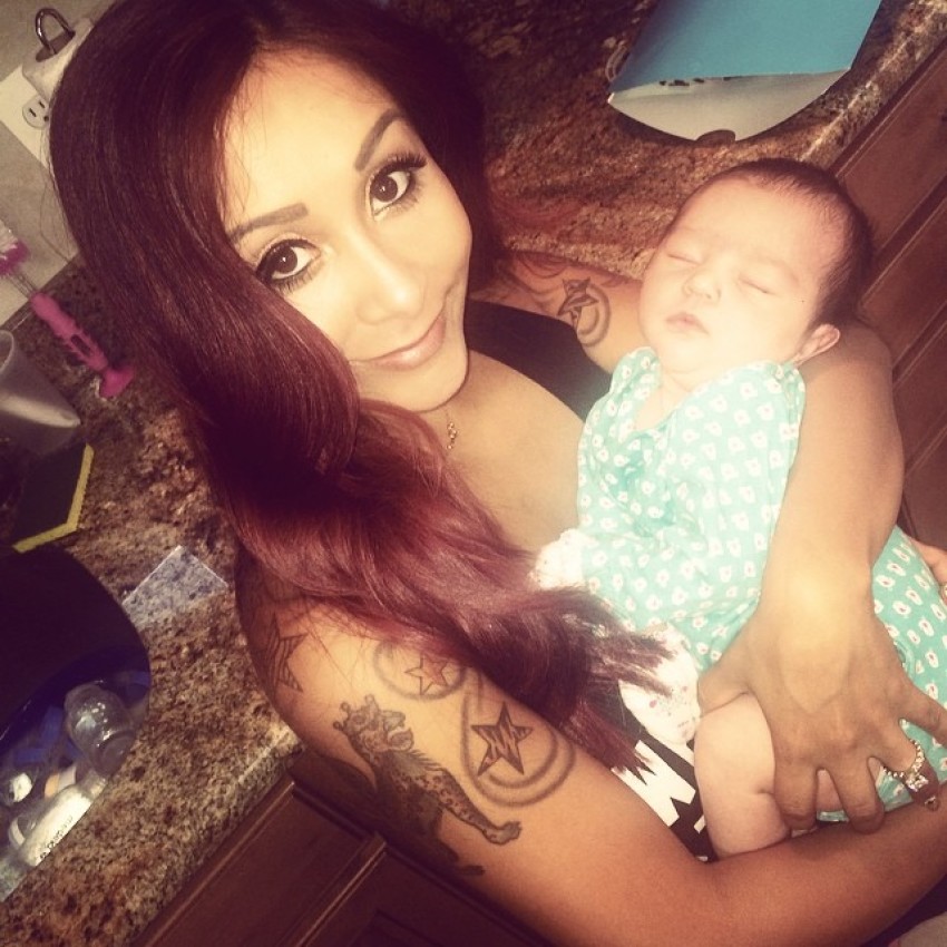 Snooki cradles her goddaughter Meilani (the daughter of Jenni "JWoww" Farley)