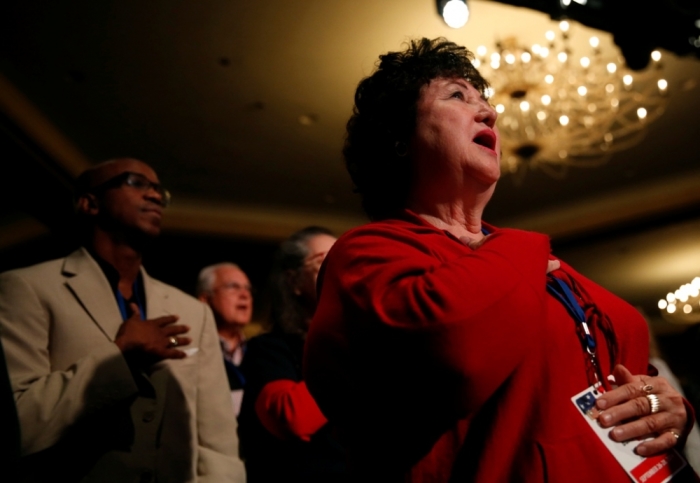 Attendees recite the Pledge of Allegiance at the morning plenary session of the Values Voter Summit in Washington, September 26, 2014.