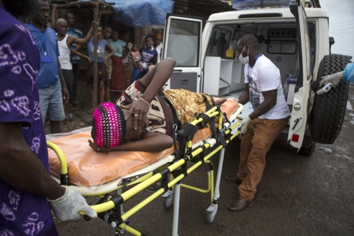 A pregnant woman suspected of contracting Ebola is lifted by stretcher into an ambulance in Freetown, Sierra Leone, September 19, 2014, in a handout photo provided by UNICEF. Sierra Leone's army has 'sealed off' the borders with Liberia and Guinea in a bid to halt the spread of Ebola, the army spokesman. The spokesman told Reuters that troops had been sent to all border crossing points.