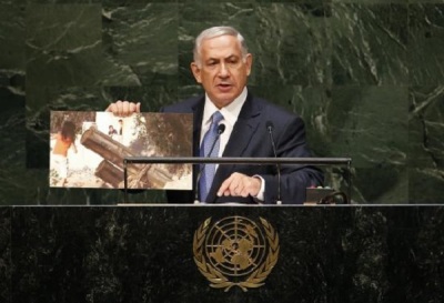 Israel's Prime Minister Benjamin Netanyahu holds up a photograph as he addresses the 69th United Nations General Assembly at the U.N. headquarters in New York September 29, 2014.