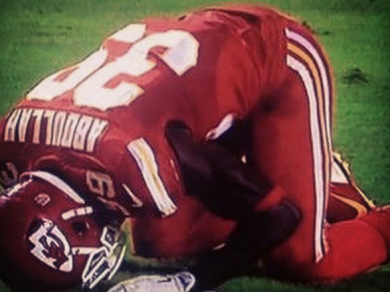 Husain Abdullah prays in the endzone of a Kansas City Chiefs game.
