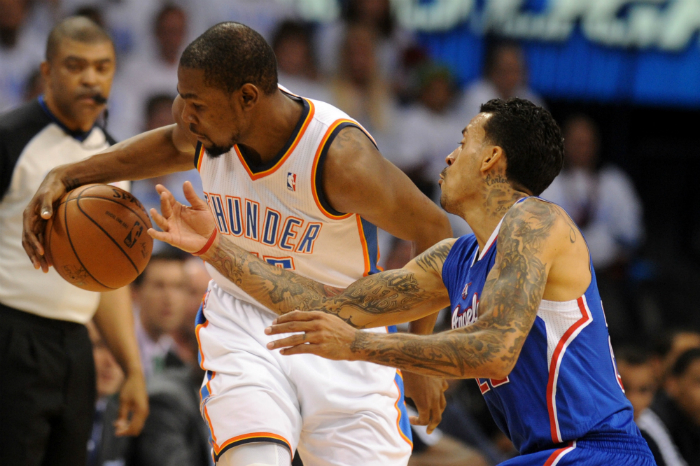 Oklahoma City Thunder Kevin Durant (left) handles the ball against Los Angeles Clippers forward Matt Barnes in game five of the second round of the 2014 NBA Playoffs.
