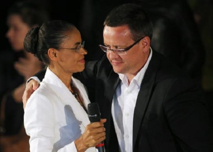 Presidential candidate Marina Silva (L) of the Brazilian Socialist Party (PSB) embraces her vice-presidential running mate Beto Albuquerque during a news conference after the official vote tally confirmed them in third place in the first round of elections, in Sao Paulo, October 5, 2014.