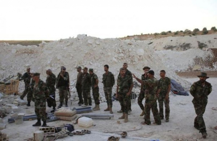 Forces loyal to Syria's President Bashar al-Assad inspect an underground base where caves were dug by rebel fighters in al-Hareeqa village, after the forces said they have regained control of the area in Hama countryside October 5, 2014.