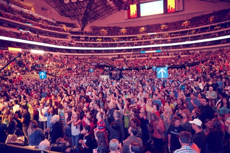 Greg Laurie, senior pastor of Harvest Christian Fellowship in Riverside, California and Harvest Orange County in Irvine, California, shares the Gospel with a sold-out crowd of 19,000 for Harvest America at the American Airlines Center and Victory Park in Dallas, Texas, Oct. 5, 2014.