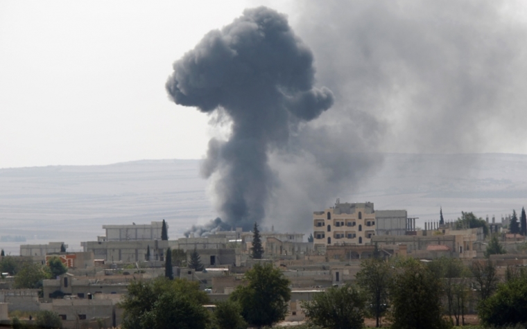 Smoke rises from the Syrian town of Kobani, seen from near the Mursitpinar border crossing on the Turkish-Syrian border in the southeastern town of Suruc, Sanliurfa province, October 3, 2014.