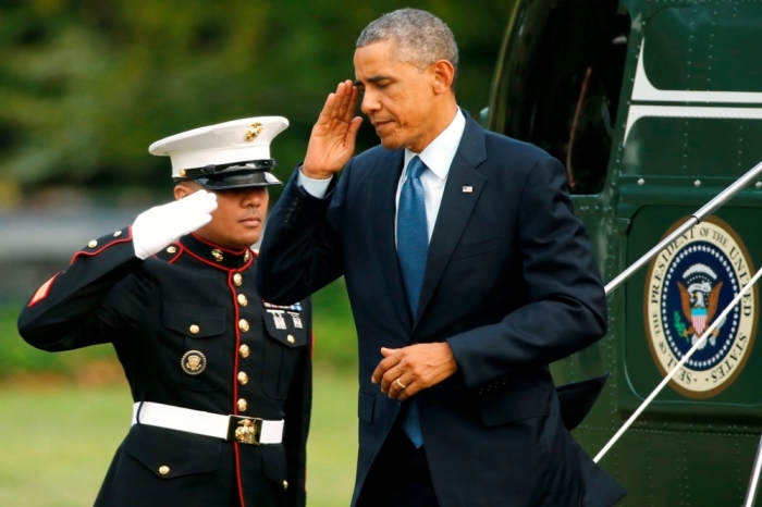 U.S. President Barack Obama returns a salute as he returns via Marine One helicopter to the White House in Washington October 2, 2014. Obama was returning from an overnight trip to Chicago, Illinois.
