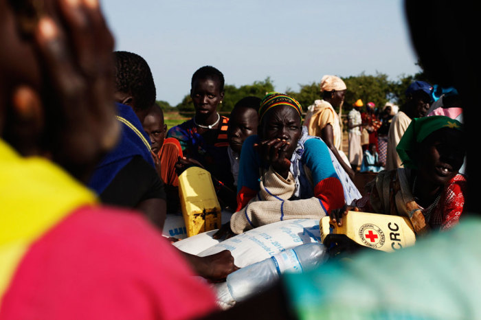 Women wait at a food distribution in Minkaman, Lakes State, June 27, 2014. About 94,000 people have sought refuge in Minkaman after fighting broke out in neighbouring states, according to the International Organization for Migration. According to OCHA, at least 3.8 million people who are facing alarming food insecurity and around 1.5 million people have been displaced by conflict.
