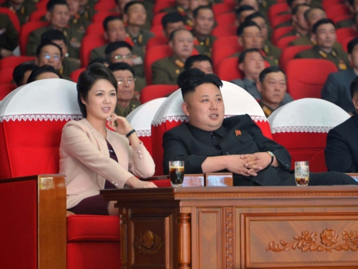 North Korean leader Kim Jong Un and his wife Ri Sol Ju watch a performance by the Moranbong Band at the April 25 House of Culture in this undated photo released by North Korea's Korean Central News Agency in Pyongyang, on March 24, 2014.