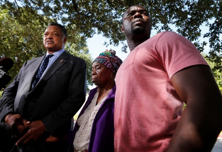 Nowai Korkoyah, the mother of Thomas Eric Duncan, the first patient diagnosed with Ebola on U.S. soil, attends a news conference with Reverend Jesse Jackson (L), and Duncan's nephew, Josephus Weeks, (R), in Dallas, Texas, October 7, 2014. Duncan, who was in critical condition and on a ventilator and kidney dialysis, died at Texas Health Presbyterian Hospital in Dallas, Wednesday, October 8, 2014.