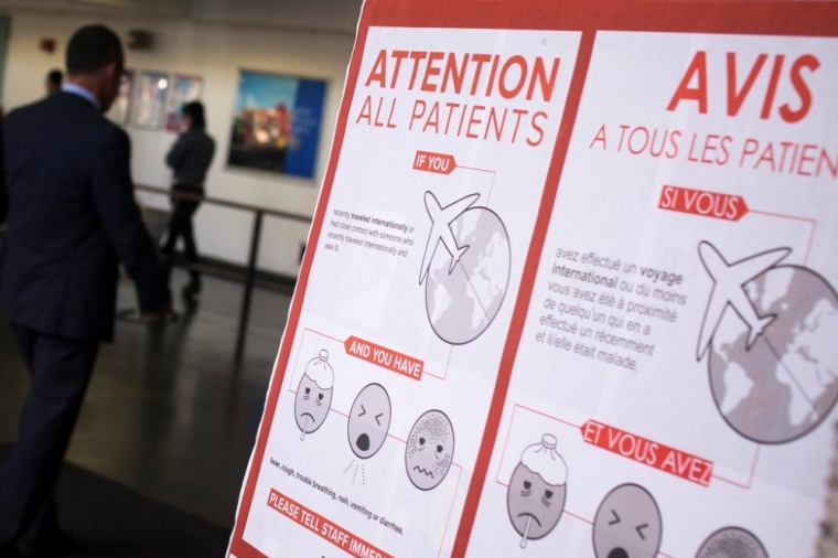 A sign asks patients to inform staff if they have fever, cough, trouble breathing, rash, vomiting or diarrhea symptoms and have recently traveled internationally or have had contact with someone who recently traveled internationally at Bellevue Hospital in Manhattan, New York, October 8, 2014. The United States will begin screening passengers arriving at U.S. airports from West Africa for fever starting this weekend, U.S. officials said on Wednesday, in the hope of avoiding an outbreak of the deadly Ebola virus.
