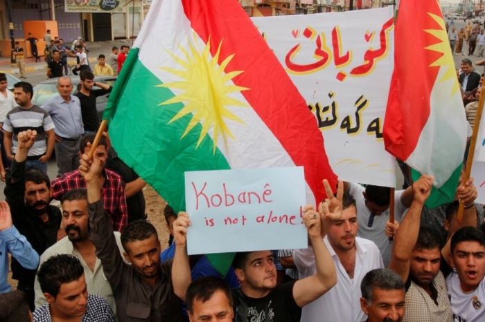 Kurdish protesters shout slogans during a rally in the northern Iraqi oil city of Kirkuk, to show support for the Syrian town of Kobani, October 9, 2014. People in Kirkuk staged a rally on Thursday in support of Kobani, calling for swift action to save the area from the grip of Islamic State militants.