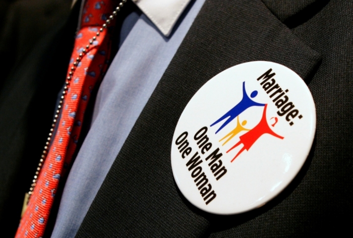 A supporter of traditional marriage wears a pin to an event in which [U.S. President George W. Bush] spoke about the marriage protection amendment in Washington, June 5, 2006.