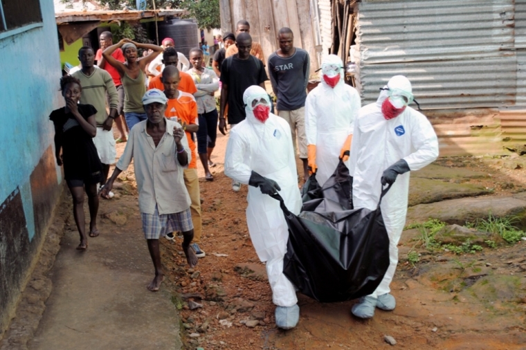 Health workers remove the body of Prince Nyentee, a 29-year-old man whom local residents said died of Ebola virus in Monrovia September 11, 2014.