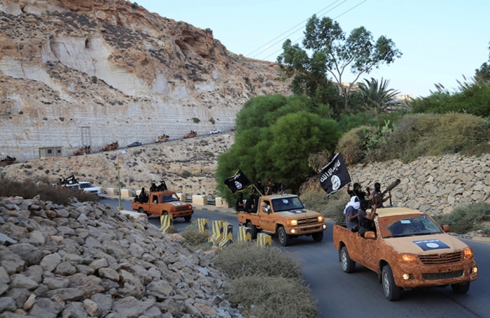 An armed motorcade belonging to members of Libya's Islamic Youth Council, consisting of former members of militias from the town of Derna, drive along a road in Derna, eastern Libya, October 3, 2014. The group announced its affiliation with ISIS in June.