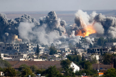 Smoke rises over the Syrian town of Kobani after an airstrike, as seen from the Mursitpinar border crossing on the Turkish-Syrian border in the southeastern town of Suruc in Sanliurfa province, October 18, 2014. U.S.-led coalition jets pounded suspected Islamic State targets at least six times in the besieged Syrian town of Kobani on Saturday after the fiercest shelling in days by the insurgents shook the town's centre and hit border areas within Turkey.